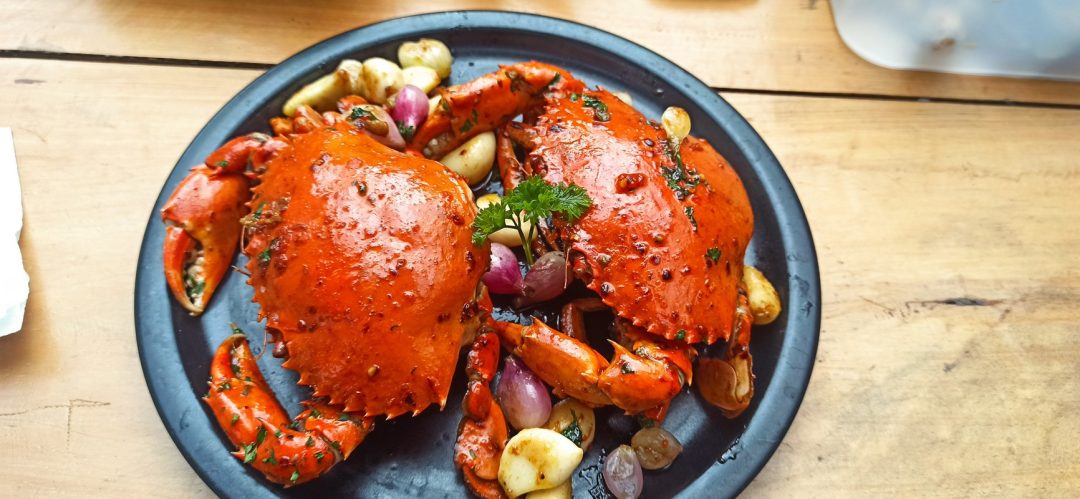 Delicious grilled crab served on a black plate